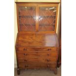 A George III mahogany bureau bookcase, the glazed top with glazing bars,