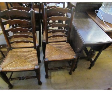 An oak gate leg dining table and four ladder back chairs