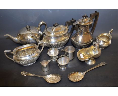 A silver plated boat shaped tea service, half fluted; a pair of EPNS scuttle shaped table salts, with shovel spoons; a helmet