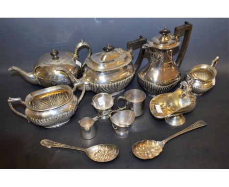 A silver plated boat shaped tea service, half fluted; a pair of EPNS scuttle shaped table salts, with shovel spoons; a helmet