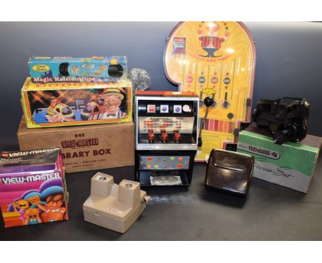 Toys - Viewmaster, assorted viewers, slides; a bagatelle game; slot-machine, boxed; Funfair Dogdem, boxed; a Disney kaleidosc