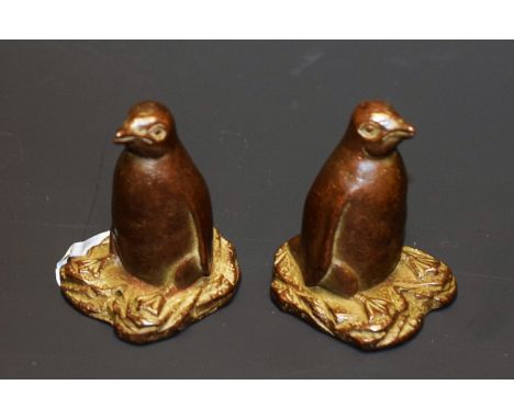 A bronze coloured metal model of a penguin, 4.5cm high; another (2)