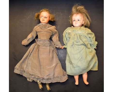 A 19th century wax shoulder doll, blue eyes, moulded mouth, light brown wig, cloth body, waxed over lower arms and legs, wear
