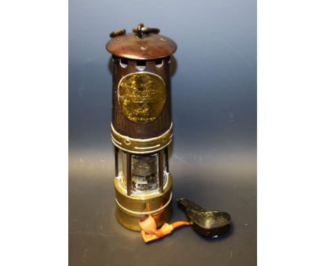 A Hailwoods miners lamp; a meerschaum pipe, as a hand, amber mouthpiece, cased (2)