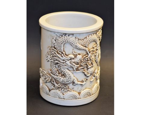 A porcelain bitong brush pot, decorated with a dragon chasing the pearl of wisdom, 13.5cm high