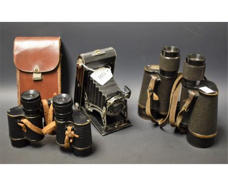 A pair of Russian field binoculars, AV 8x40, with hammer sickle mark, serial number NA2144, 1936; a pair of Metropax 8x25 fie