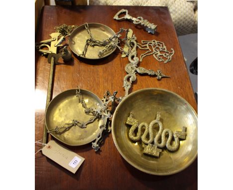 Two sets of Victorian style cast brass balance scales, a Chinese brass serpent plaque and oneother.