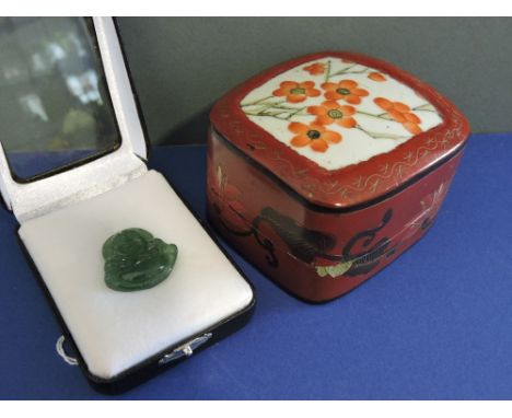 A Chinese carved jade Buddha pendant, 3cm, together with a lacquer box with ceramic inset cover.