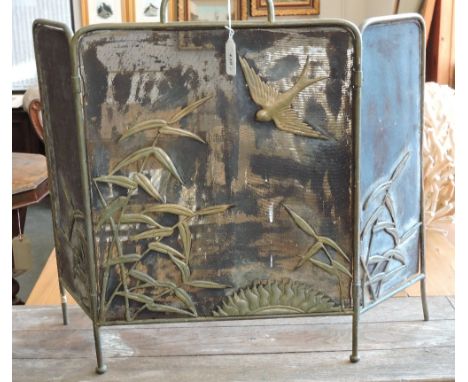A late Victorian brass mesh fire screen decorated with a swallow and sun motif among leaves.