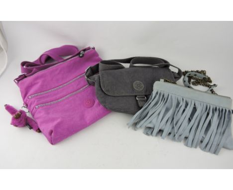 A cerise cloth shoulder bag by Kipling, together with a similar small grey bag and a light blue leather bag, (3)