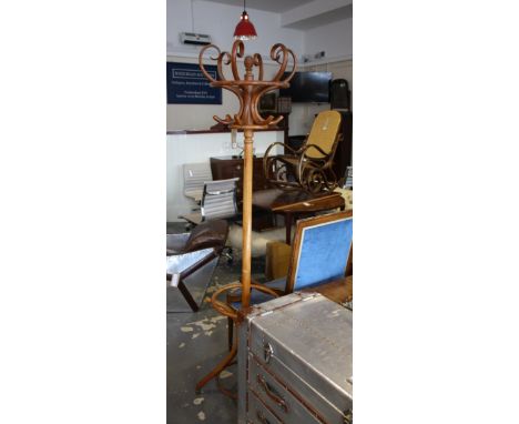 A Thonet style bentwood coat and stick stand on quadruple scroll support, stamped 7354.