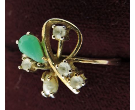 A jade, pearl and white stone ring, modern scroll set in a yellow metal band.