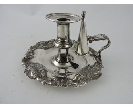 A 19th century Sheffield plate chamber stick with associated snuffer, the dish decorated with a grapevine motif, D. 17cm. 