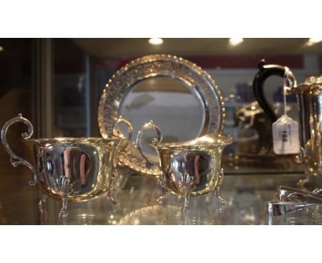 Silverplated four piece tea service on shell cast feet together with 2 pairs of tongs, spoon cake knife and a pair of pierced