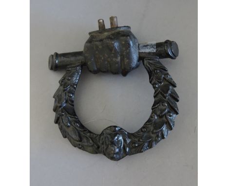 An early Victorian cast iron door knocker, in the form of a clasped hand and wreath, said to commemorate the victories and de