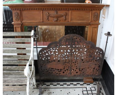 An Adam design pine fire surround together with a wrought iron pierced fire screen.