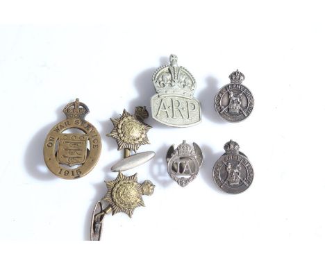 A First World War 'On War Service' badge dated 1915, serial number 32780 to reverse, together with two silver Royal Army Rese