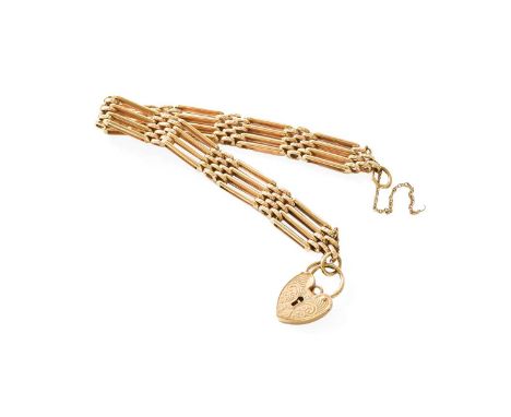 A Gate Link Bracelet, comprising textured and plain polished links, stamped '375', with a 9 carat gold heart shaped padlock c