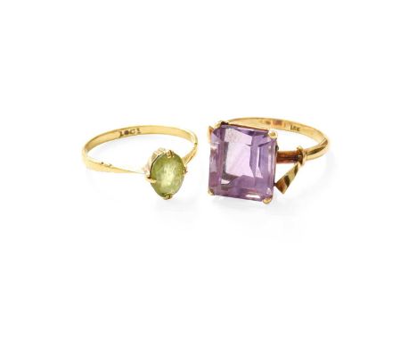 An Amethyst Ring, the emerald-cut amethyst in a yellow claw setting, to a fancy shoulder plain polished shank, finger size N;