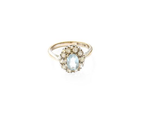 An 18 Carat White Gold Aquamarine and White Spinel Cluster Ring, the oval cut aquamarine within a border of round cut white s