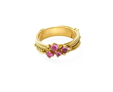 A Synthetic Ruby Ring, four round cabochon synthetic rubies in yellow claw settings, to an abstract band, finger size NIn our