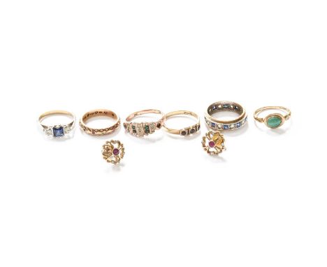Six Rings, comprising of two 9 carat gold eternity rings, finger size J1/2 and L; a 9 carat old garnet three stone ring, fing