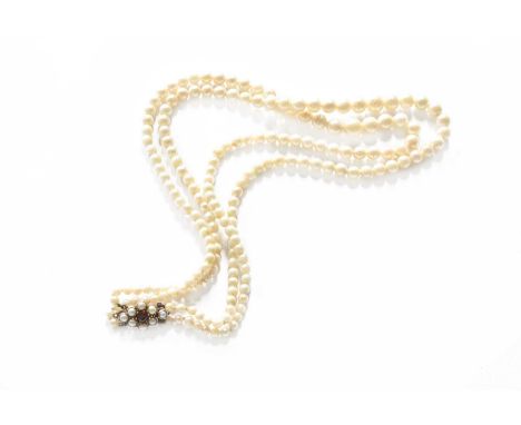 A Two Row Cultured Pearl Necklace, with a 9 carat gold garnet and cultured pearl cluster clasp, length 43cmGross weight 33.6 
