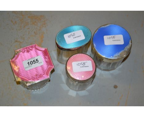 Four various silver enamel mounted glass dressing table jars, with damages