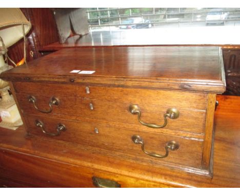 George III oak carpenters tools cabinet with a hinged cover above two drawers with brass swan neck handles and side carrying 