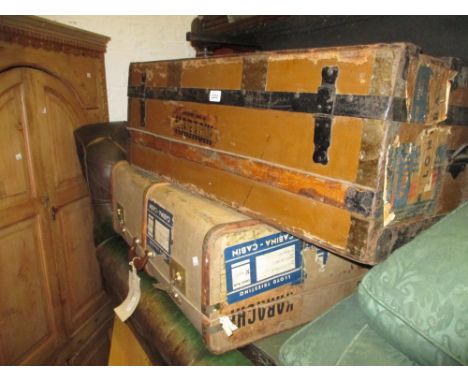 Two early 20th Century cabin trunks with some luggage labels and a metal bound trunk