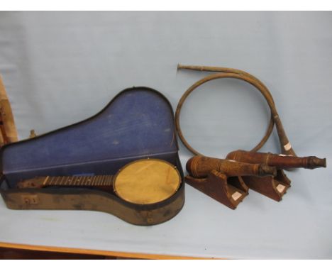 Cased banjolele by Keech (lacking strings), together with a copper hunting horn (a/f) and a pair of model canons