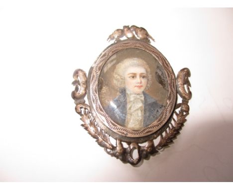 Oval gilt metal mounted watercolour portrait miniature of a lady wearing a white blouse