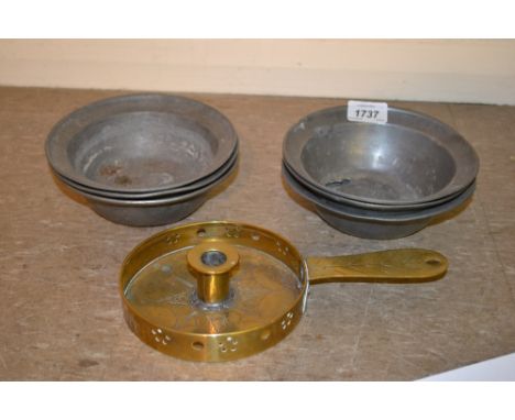 Set of six pewter bowls with touch marks and a brass engraved chamber stick