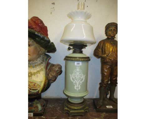 Pate sur pate style porcelain and gilt brass mounted oil lamp, decorated with a classical figure of an angel with opaque glas