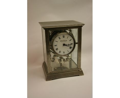 Rare 1930's Atmos clock by J.L. Reutter, the silvered brass case enclosing an enamel dial with Roman numerals, the dial inscr