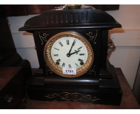 19th Century black slate and gilt decorated mantel clock with lion mask side handles, the enamel dial with Roman numerals and