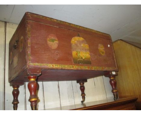 19th Century Continental painted pine trunk with hinged cover and brass carrying handles, on turned supports with brass caps 