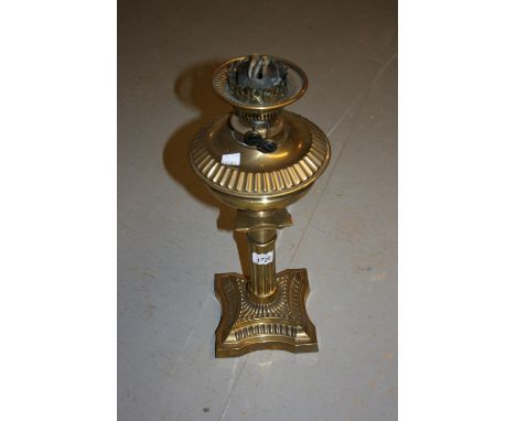Late 19th or early 20th Century brass oil lamp and well with clear glass shade and chimney