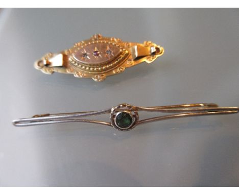 15ct White and yellow gold bar brooch set single peridot together with a 9ct gold brooch set single pink ruby and two small d