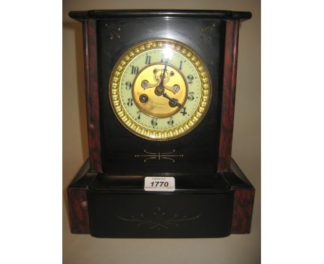 Black slate and rouge marble two train mantel clock with a visible escapement, the dial signed Reboulet Montelimar