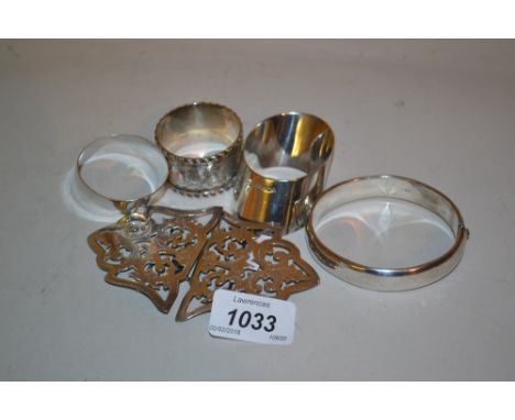 Birmingham silver nurses buckle, three various silver napkin rings and a silver bangle