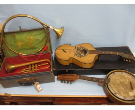 Brass cornet in case together with a brass hunting horn, a banjo mandolin and another mandolin (a/f)