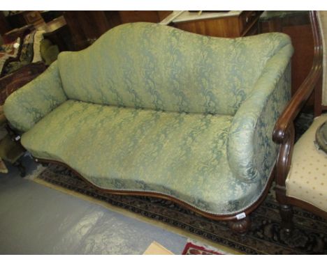 Victorian green floral upholstered three seater sofa with a serpentine front raised on carved walnut and turned front support