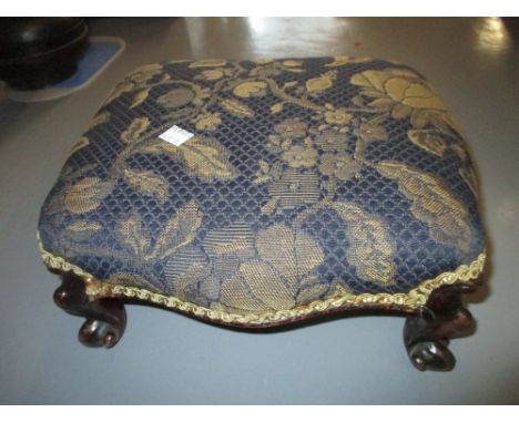 Small Victorian carved walnut footstool with an overstuffed seat on cabriole supports together with a mahogany firescreen wit
