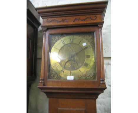 18th Century oak longcase clock with a square hood above a rectangular panelled door and a plinth base, the brass dial with A