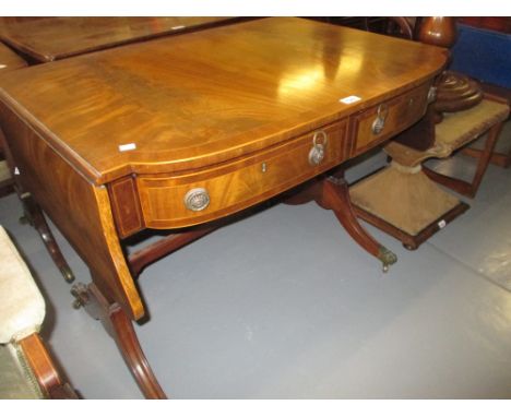 Mahogany drop-leaf bow front sofa table having crossbanded and line inlaid top above two short drawers with brass ring handle