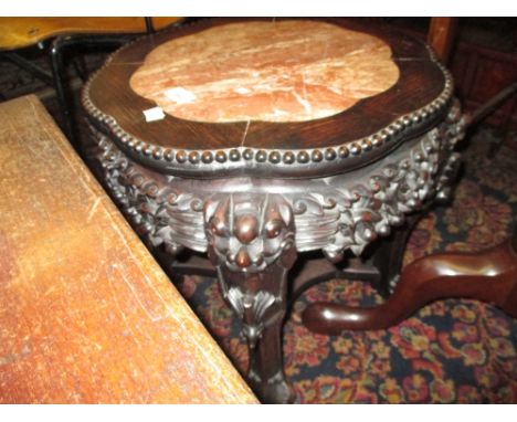 19th Century Chinese carved hardwood vase stand, the rouge marble inset top above a carved frieze on carved cabriole supports