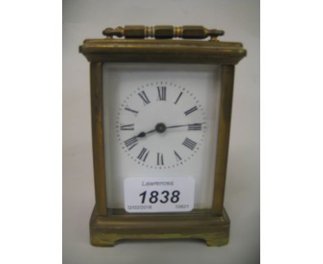 20th Century brass cased travelling clock, having enamel dial with Roman numerals