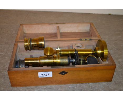 Early to mid 20th Century gilt brass monocular microscope in a fitted walnut box with various accessories