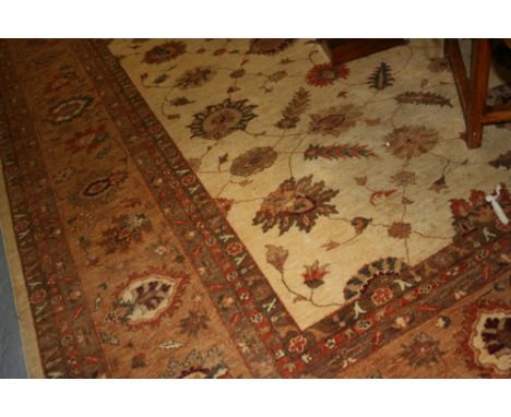 Large Afghan Ziegler carpet having all-over floral design with multiple borders on a beige ground, approximately 14ft x 11ft